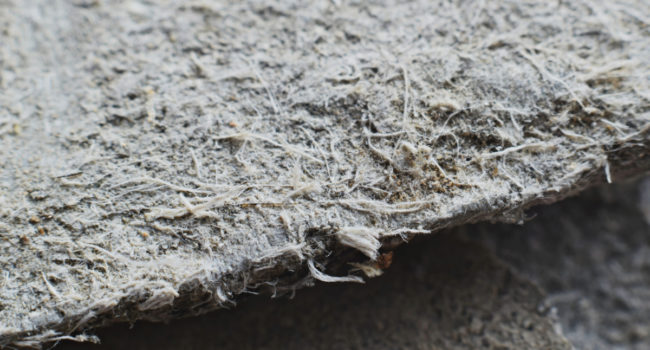 Detailed photography of roof covering material with asbestos fibres. Health harmful and hazards effects. Prolonged inhalation of microscopical fibers causes fatal illnesses including lung cancer.